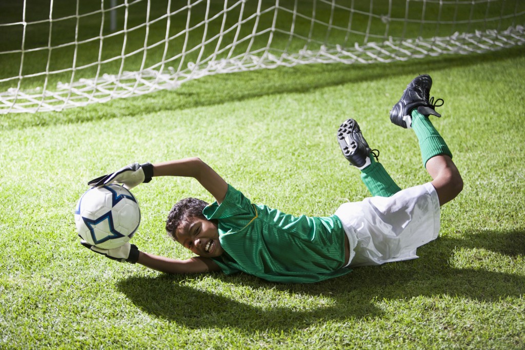 Soccer goalie saving a goal